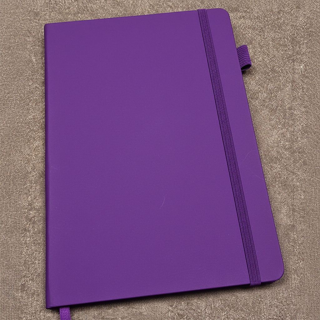 Purple journal with a strap on a brown surface