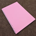 Pink notebook on a brown textured background