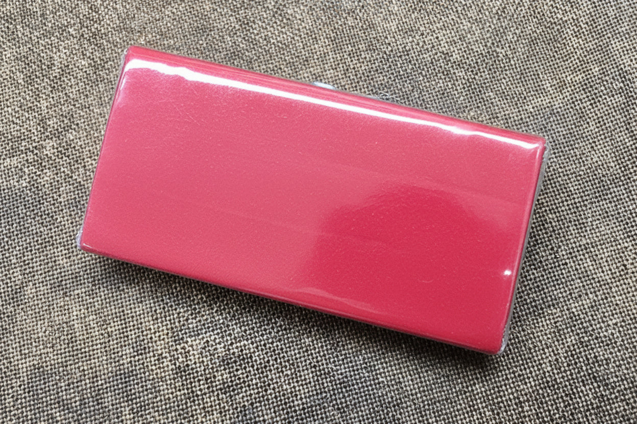 Red rectangular eraser on a textured gray surface