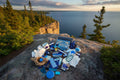 Collection of blue-themed items on a brown surface that overlooks a large lake