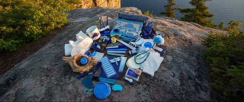 Collection of blue-themed items on a brown surface that overlooks a large lake