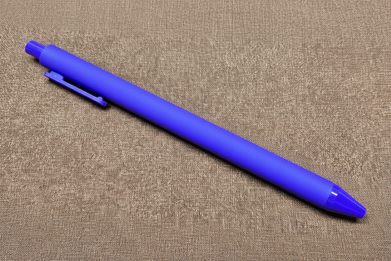 Purple pen on a textured brown surface